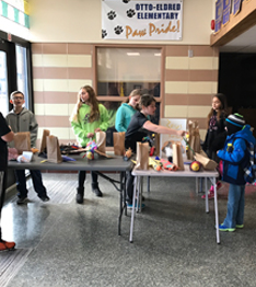 Students display a project in a hall