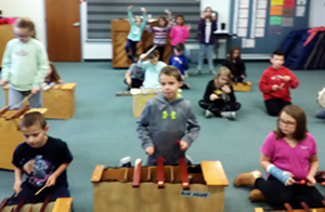 Elementary students playing instruments in the classroom