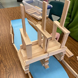 students building a bridge out of popsicle sticks