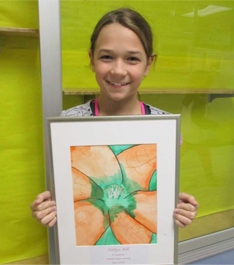 Female student holding up artwork